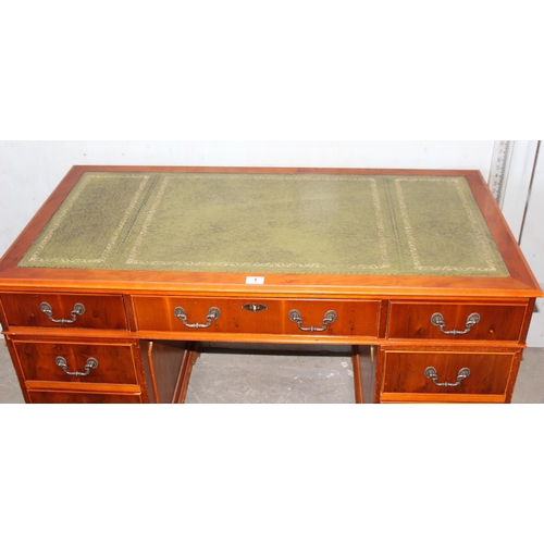 1 - A leather topped yew wood finished pedestal desk, approx 122cm wide