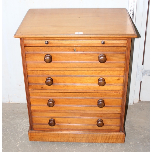 11 - An antique 4 drawer mahogany chest of drawers with brushing slide and turned wooden handles