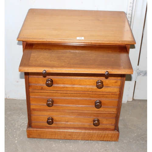 11 - An antique 4 drawer mahogany chest of drawers with brushing slide and turned wooden handles