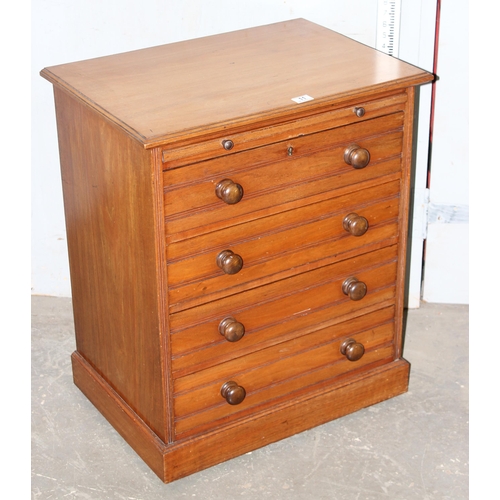 11 - An antique 4 drawer mahogany chest of drawers with brushing slide and turned wooden handles