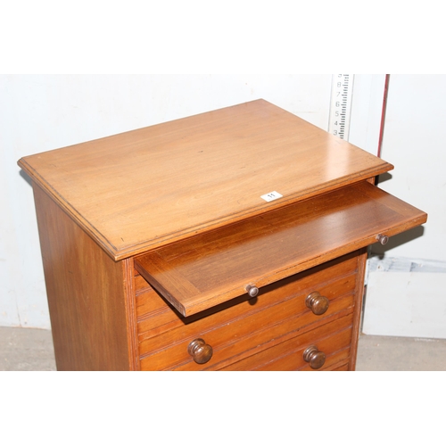 11 - An antique 4 drawer mahogany chest of drawers with brushing slide and turned wooden handles