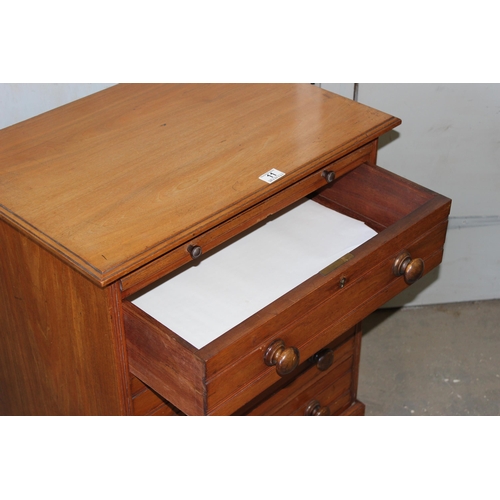 11 - An antique 4 drawer mahogany chest of drawers with brushing slide and turned wooden handles