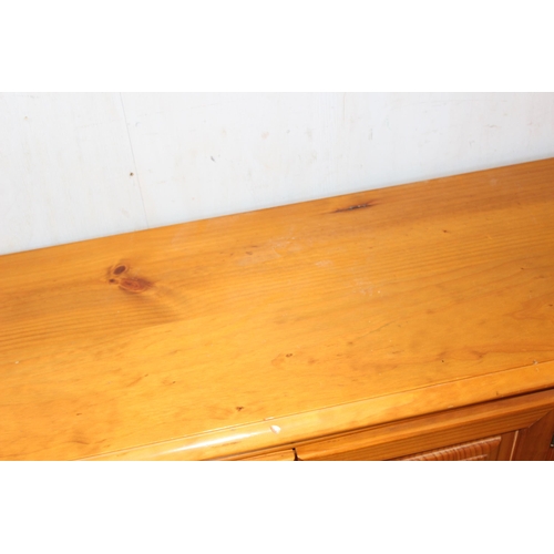 24 - A long low pine sideboard, approx 207cm wide