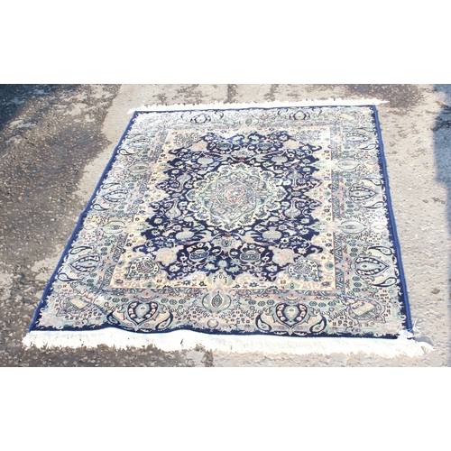 202 - A modern decorative blue ground rug, approx 175cm x 125cm