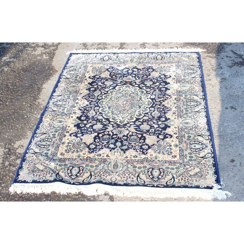 202 - A modern decorative blue ground rug, approx 175cm x 125cm