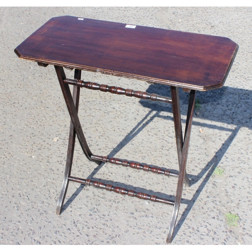 27 - A small antique mahogany folding serving table with turned stretchers