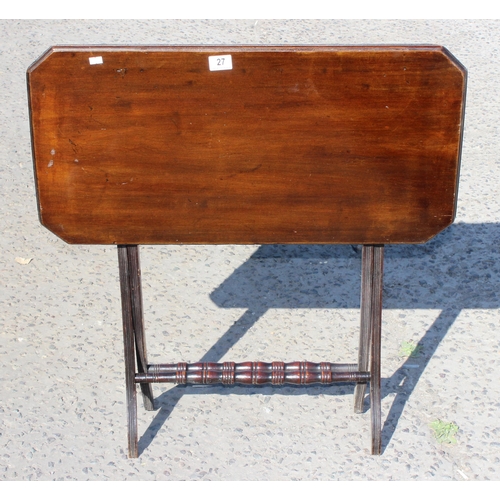 27 - A small antique mahogany folding serving table with turned stretchers