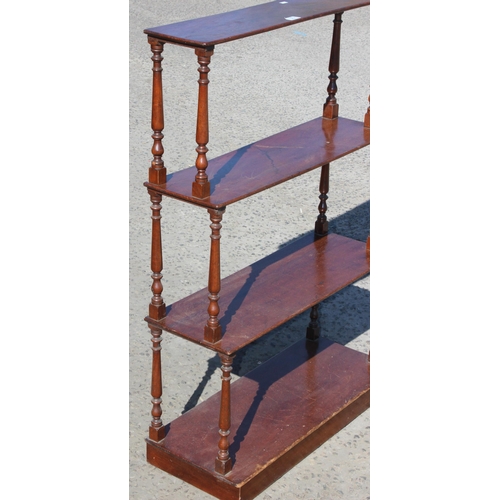 33 - A Victorian 4 tier mahogany waterfall bookcase with turned supports