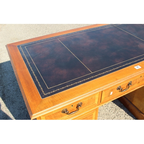 46 - A modern yew effect leather topped pedestal desk