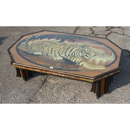 54 - An unusual large wooden and glazed coffee table formed with a fretwork scene of a Tiger