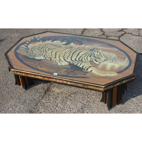 54 - An unusual large wooden and glazed coffee table formed with a fretwork scene of a Tiger