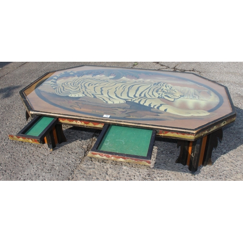 54 - An unusual large wooden and glazed coffee table formed with a fretwork scene of a Tiger