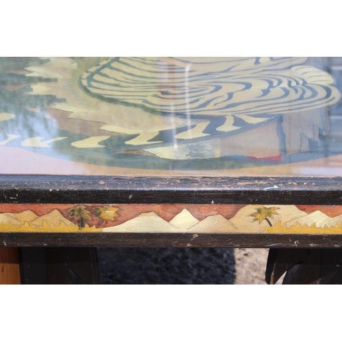 54 - An unusual large wooden and glazed coffee table formed with a fretwork scene of a Tiger