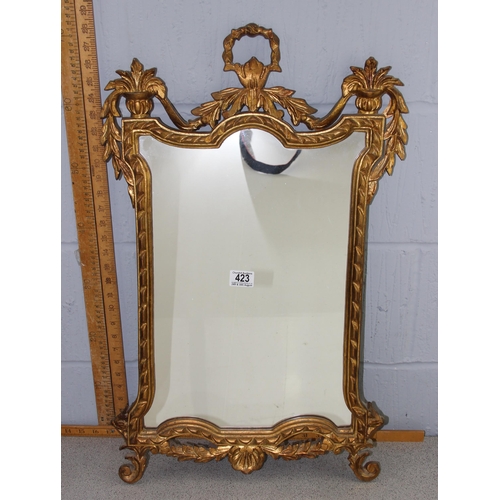 423 - An ornate Rococo style gilt framed mirror