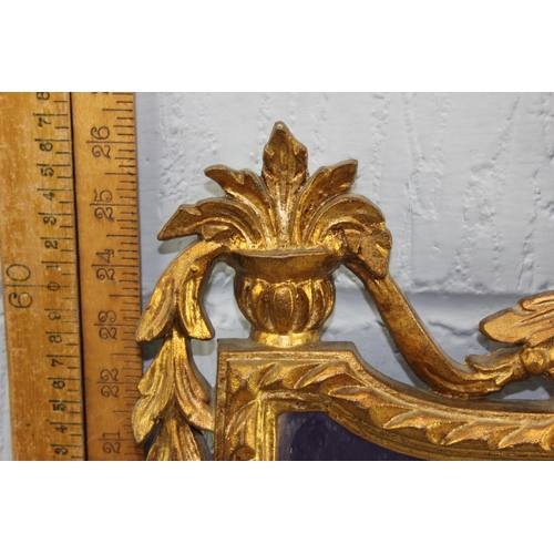 423 - An ornate Rococo style gilt framed mirror