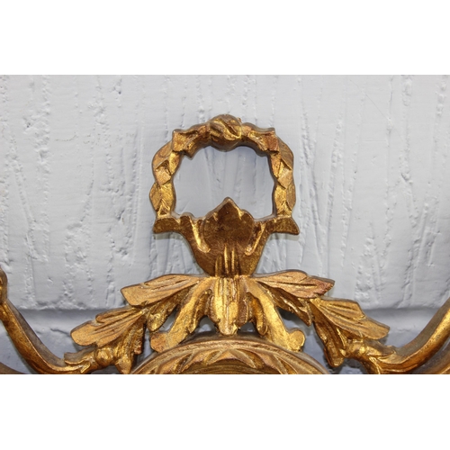 423 - An ornate Rococo style gilt framed mirror