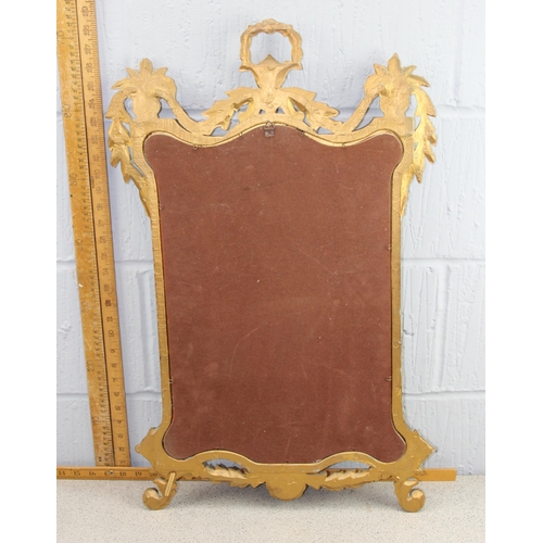 423 - An ornate Rococo style gilt framed mirror