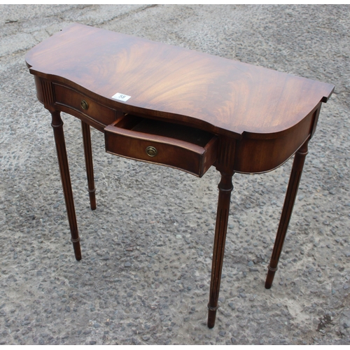 58 - An antique style mahogany console or hall table with 2 drawers