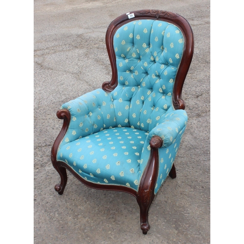 64 - An antique style low armchair with carved details and turquoise upholstery