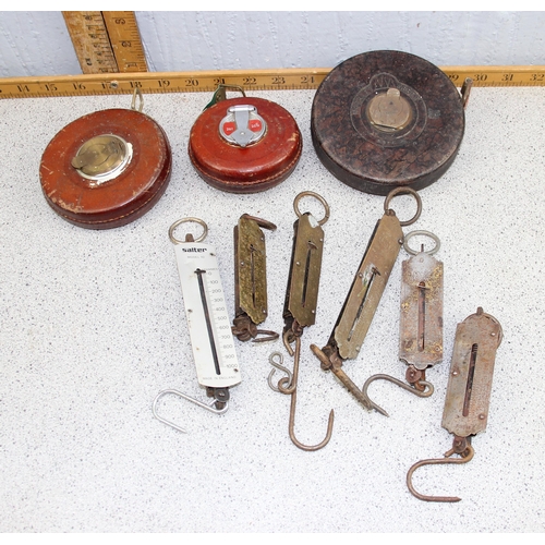 708 - 3 vintage leather covered tape measurers, various spring balances etc