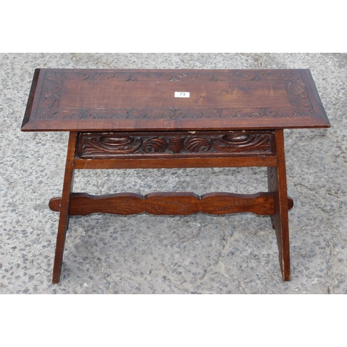 73 - An Arts & Crafts period oak table with single drawer and carved details