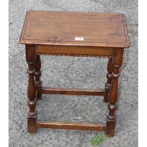 74 - An antique oak coffin stool with carved details and turned legs