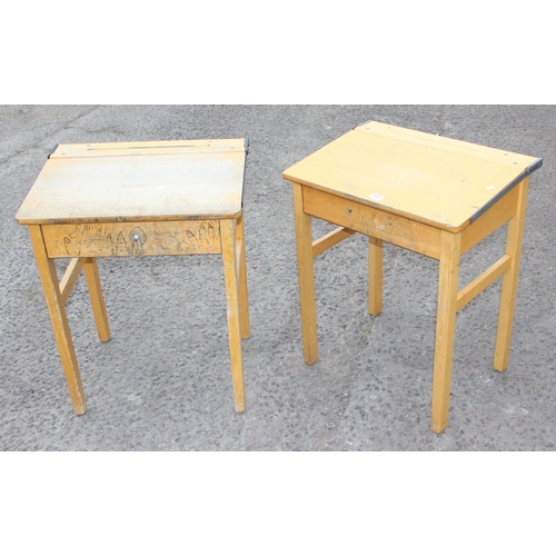 137 - A pair of vintage wooden school desks