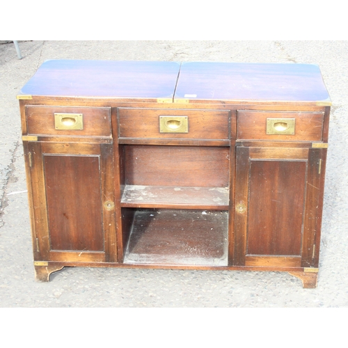 138 - A 20th century campaign style sideboard or drinks cabinet with 3 drawers over 2 cupboards and a slid... 