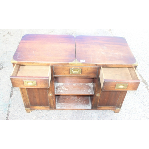 138 - A 20th century campaign style sideboard or drinks cabinet with 3 drawers over 2 cupboards and a slid... 