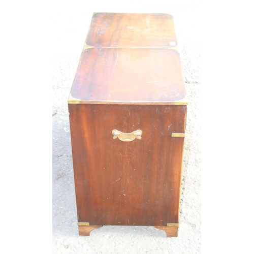 138 - A 20th century campaign style sideboard or drinks cabinet with 3 drawers over 2 cupboards and a slid... 