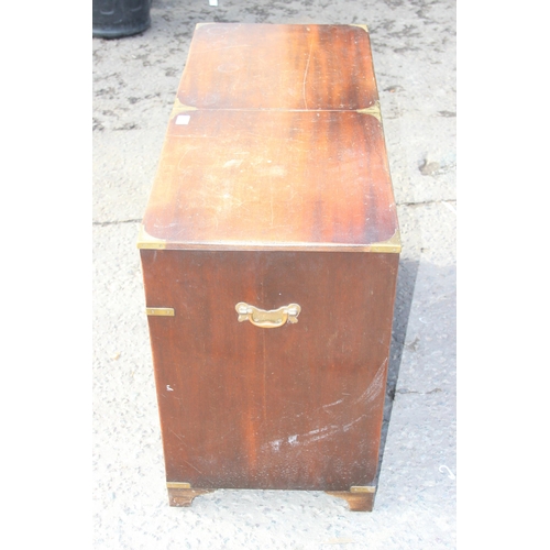 138 - A 20th century campaign style sideboard or drinks cabinet with 3 drawers over 2 cupboards and a slid... 