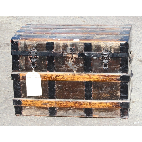 139 - An early 20th century wooden and iron bound travel trunk