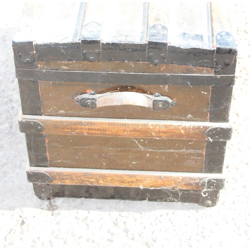 139 - An early 20th century wooden and iron bound travel trunk