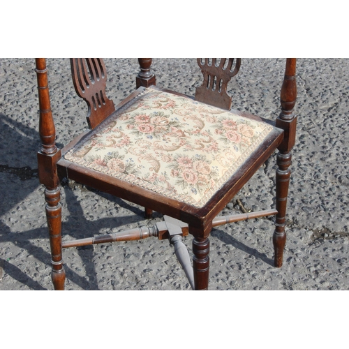 142 - An antique Edwardian corner chair with upholstered seat