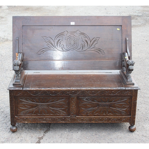 124 - British made 20th century carved oak monk's bench with lion details