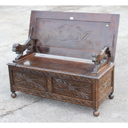 124 - British made 20th century carved oak monk's bench with lion details