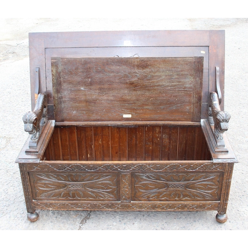 124 - British made 20th century carved oak monk's bench with lion details