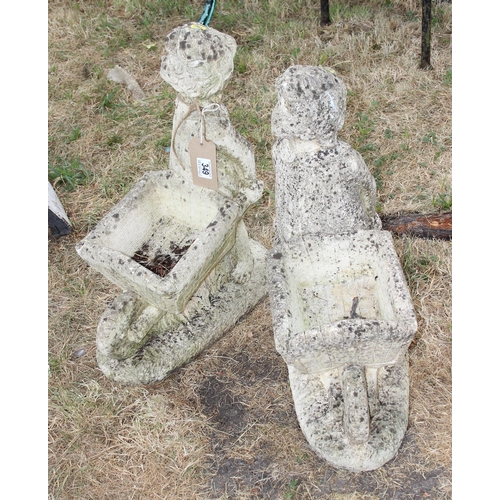 349 - A pair of weathered concrete garden planters formed a girls with barrows