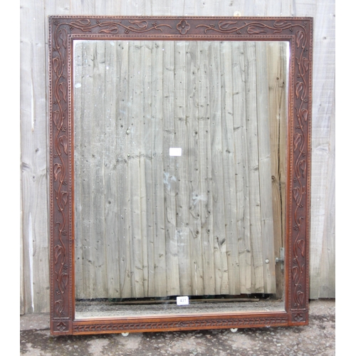 431 - A large Arts & Crafts period oak framed mirror with carved details, approx 109cm x 89cm