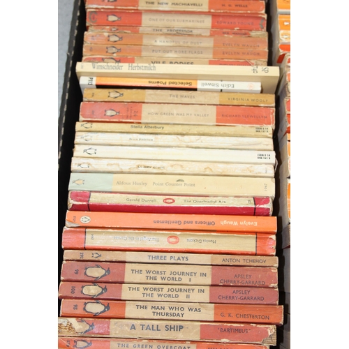 567 - A box of assorted vintage paperback books, mainly orange Penguin books