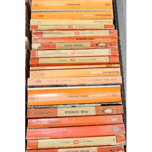 567 - A box of assorted vintage paperback books, mainly orange Penguin books