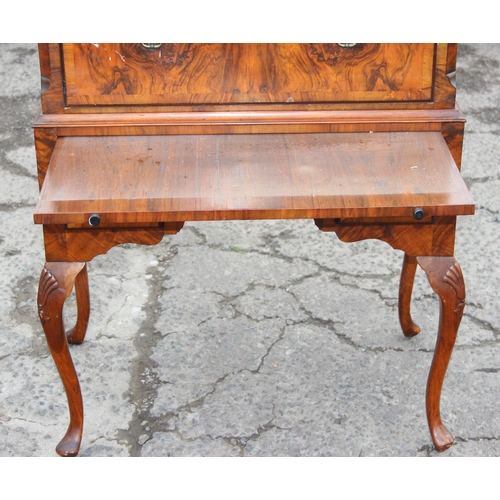 91 - A Queen Anne style walnut chest on stand with dressing slide, likely early 20th century, oak drawer ... 