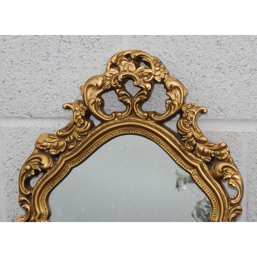 449 - A Rococo style gilt framed plaster mirror