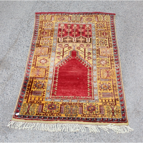 212 - A vintage hand knotted prayer rug of yellow and red ground, approx 220cm x 140cm