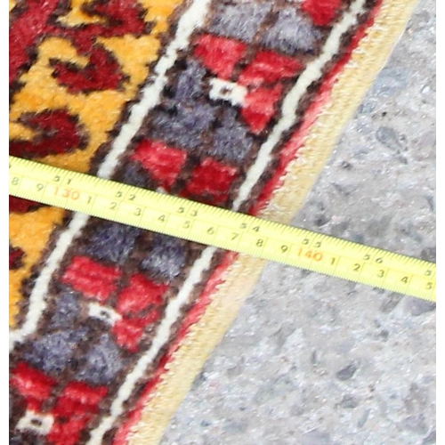 212 - A vintage hand knotted prayer rug of yellow and red ground, approx 220cm x 140cm