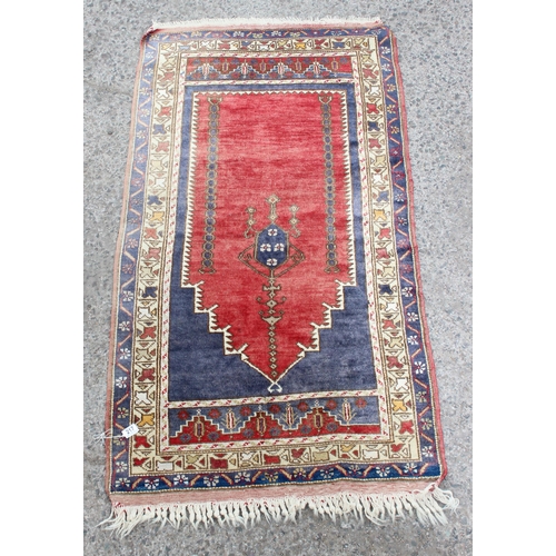 217 - A vintage hand knotted prayer rug of blue and red ground, approx 180cm x 85cm