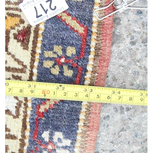 217 - A vintage hand knotted prayer rug of blue and red ground, approx 180cm x 85cm