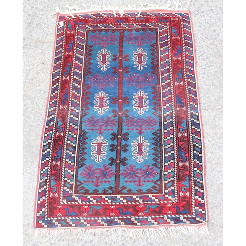 221 - A decorative vintage hand knotted rug of red and blue ground with various geometric patterns, approx... 