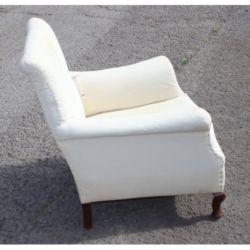 87 - A Victorian deep seated armchair in the manner of Howard & Sons, ready for upholstery