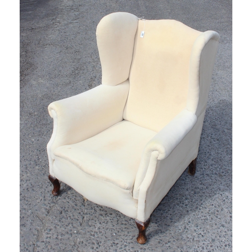 88 - An antique wingback armchair with sprung seat, ready for upholstery